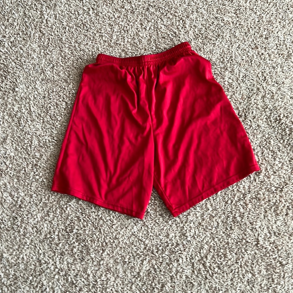 Used red gym shorts size medium.